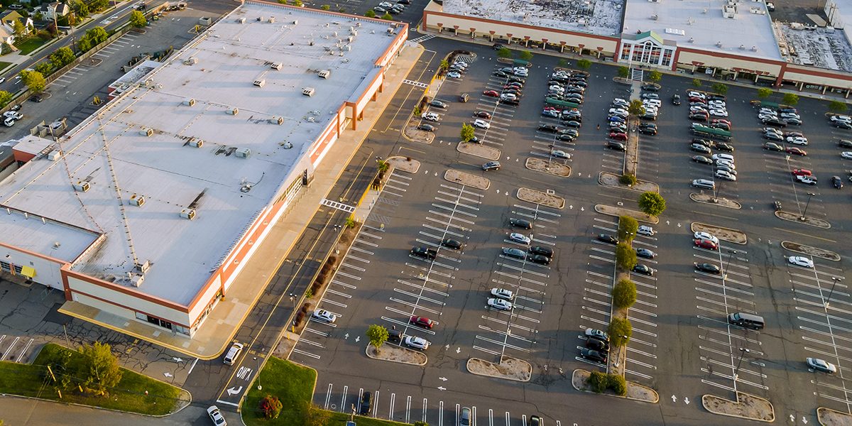 Aerial view shopping mall exterior with parking lot space